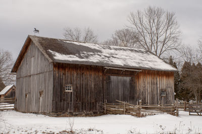 Abandoned barn on snow covered field 