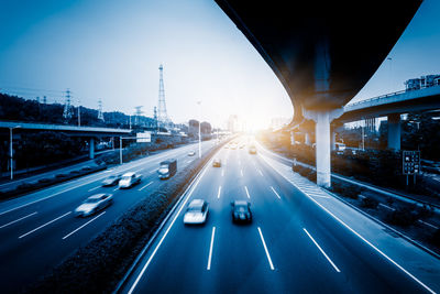 Blurred motion of highway against sky in city