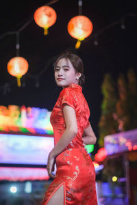 Portrait of beautiful asian woman wearing red dress in chinese new year festival.