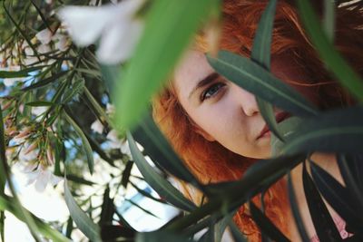 Close-up portrait of woman by plants