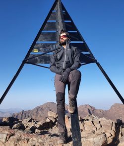 Low angle view of man standing on toubkal summit