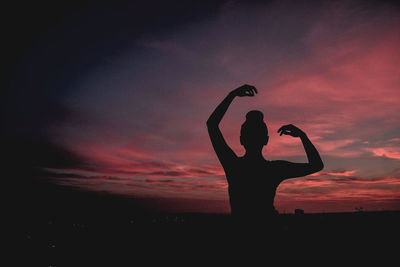 Silhouette of woman against sky during sunset