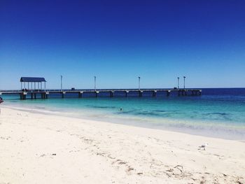 Scenic view of calm sea against clear blue sky