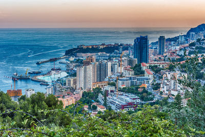 High angle view of sea and buildings against sky