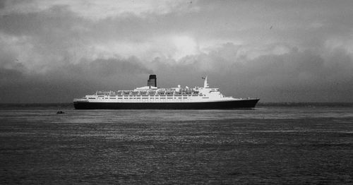 Ship sailing on sea against sky