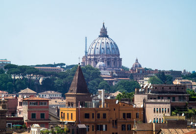 Buildings in city against clear sky