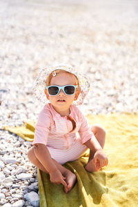 Portrait of young woman wearing sunglasses on beach