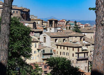 Buildings in town against clear sky