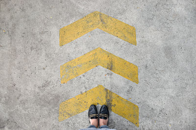High angle view of arrow sign on road