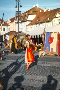 Woman walking on street in city