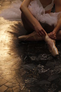 Low section of woman sitting on floor