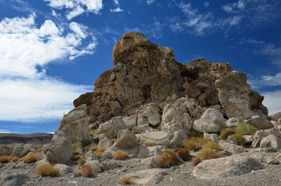 Low angle view of rock formation against sky