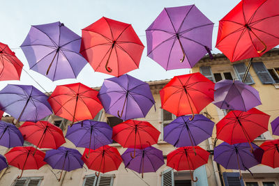 Low angle view of multi colored umbrellas hanging on clothesline