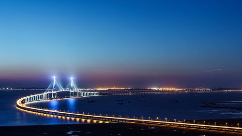 High angle view of illuminated bridge over river at night