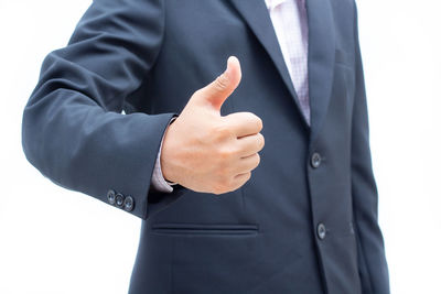 Midsection of man standing against white background