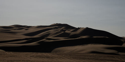 Scenic view of desert against clear sky