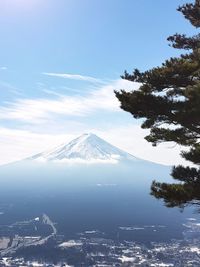 Scenic view of snowcapped mountains against blue sky