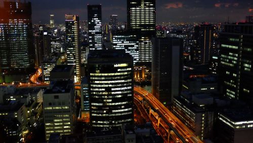 High angle view of illuminated buildings in city at night