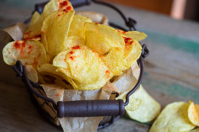 High angle view of fresh crunchy potato chips on table