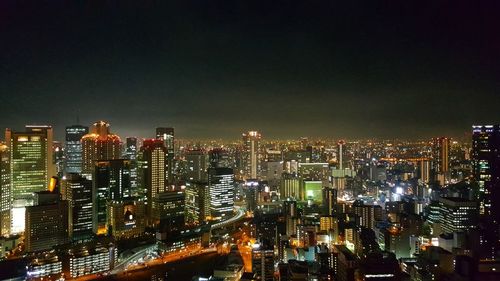 High angle view of illuminated buildings against sky at night