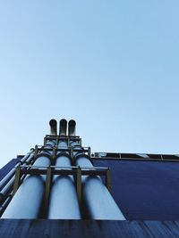 Low angle view of pipelines against clear sky