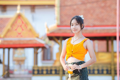 Portrait of young woman standing outdoors