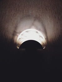 High angle view of illuminated light bulb on wall