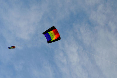 Low angle view of kite flying against sky