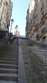 Street amidst buildings in city against sky