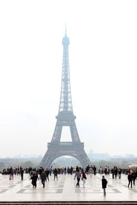 People in front of tower against clear sky
