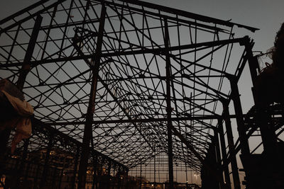 Low angle view of silhouette building against sky