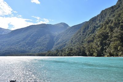 Scenic view of sea and mountains against sky