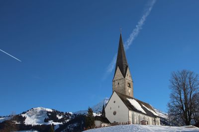 Low angle view of building against clear blue sky