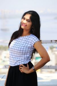 Portrait of smiling woman standing outdoors