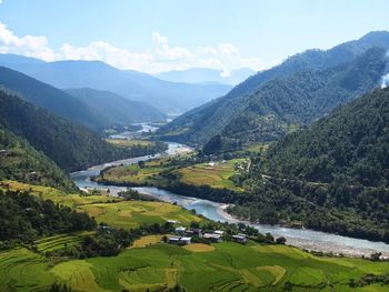 Scenic view of river flowing through green mountains