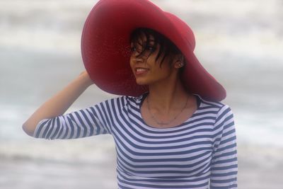 Young woman in red hat at beach