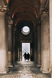 Rear view of silhouette people walking in corridor