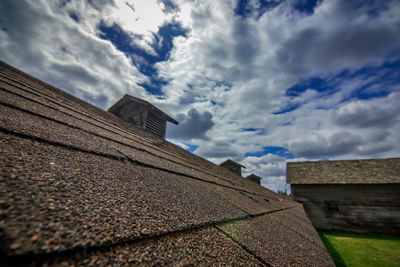 Low angle view of house roof against sky