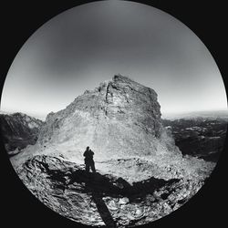 Silhouette man against mountains against clear sky