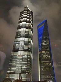 Low angle view of modern building against sky at night