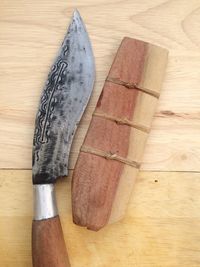 Close-up of knife on wooden table