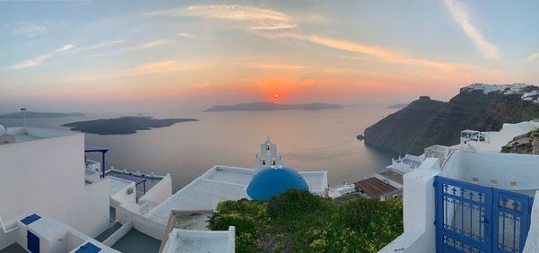High angle view of buildings and trees against sky during sunset