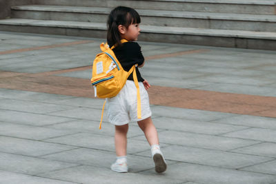 Full length of girl standing outdoors