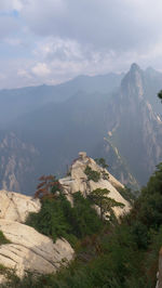 Scenic view of mountains against cloudy sky