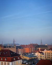 High angle shot of townscape against blue sky