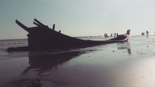 Boat moored on sea against sky