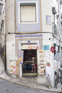 Man standing on wall in city