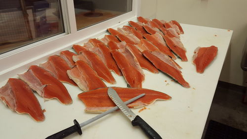 High angle view of seafood and knife on table