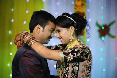 Side view of young couple during wedding ceremony