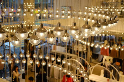 Row of illuminated lights hanging in restaurant